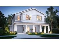 New two-story home showcasing a welcoming front porch with a well-manicured lawn and tasteful landscaping at 807 E Ida St # 1, Tampa, FL 33603
