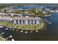 Waterfront condo building with boat docks along a canal with waterway views, showcasing coastal living at 8141 Aquila St # 346, Port Richey, FL 34668