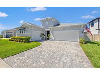 Charming single-Gathering home featuring manicured lawn and beautiful landscaping under a sunny sky at 8919 Drummer Plank Dr, Wesley Chapel, FL 33545
