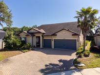 Charming home featuring a three-car garage and a beautifully brick-paved driveway for added curb appeal at 10404 Scarlet Chase Dr, Riverview, FL 33569