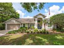 Charming two-story home boasts manicured landscaping and inviting curb appeal with its beautiful lawn at 18106 Woodcreek Pl, Lutz, FL 33548