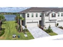 Charming townhome with a two-car garage, set against a backdrop of serene water views at 19195 Blue Pond Dr, Lutz, FL 33558