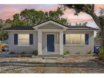 Charming single-story home features a gray exterior, dark blue door, and well-maintained landscaping at 419 40Th S Ave, St Petersburg, FL 33705
