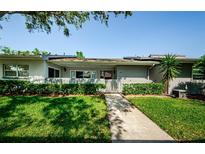 Inviting home exterior featuring a walkway, tidy landscaping, and a charming picket fence and front porch at 70 Ashley Ln, Oldsmar, FL 34677
