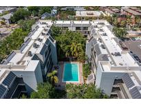 Stunning aerial view of condo building with a community pool surrounded by lush landscaping at 105 4Th Ne Ave # 219, St Petersburg, FL 33701