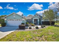 Charming single-story home with a well-manicured lawn and lovely landscaping at 17364 Mediterranean Cir, Weeki Wachee, FL 34614