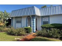 Charming home featuring a light blue metal roof and decorative iron door at 4237 Tamargo Dr # 4237, New Port Richey, FL 34652