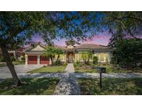 Charming single-story home featuring a red tile roof, well-manicured lawn, and a welcoming two-car garage at 5316 Candler View Dr, Lithia, FL 33547
