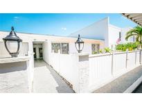 Charming condo featuring a well-maintained exterior, white picket fence and lovely landscaping at 1655 S Highland Ave # F126, Clearwater, FL 33756