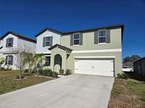 Two-story home with a two-car garage, neutral paint, and simple landscaping for a clean, modern look at 238 Argyll Dr, Spring Hill, FL 34609