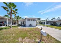 Charming single-story home with a well-manicured lawn and a covered carport, perfect for easy parking at 264 S Port Royal Ln, Apollo Beach, FL 33572