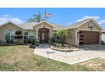 Charming single-story home featuring an inviting entrance, well-maintained landscaping, and an attached two-car garage at 13416 Algoma Ave, Spring Hill, FL 34609