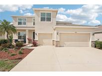 Beautiful two-story home featuring a well-maintained lawn and a three-car garage at 16709 Barnwood Pl, Bradenton, FL 34211