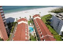 An aerial view of the condo complex showing a swimming pool and proximity to the beach at 17960 Gulf Blvd # 104, Redington Shores, FL 33708