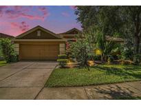 Charming single-Gathering home with manicured lawn and beautiful landscaping at 6130 Whimbrelwood Dr, Lithia, FL 33547