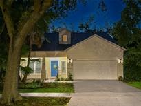 Charming single-Gathering home featuring a well-maintained lawn, welcoming front porch, and a two-car garage at 6230 Gannetdale Dr, Lithia, FL 33547