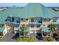 Three-story townhouse features an attached garage and a yellow stucco facade at 6451 Sunset Bay Cir, Apollo Beach, FL 33572