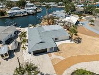 Waterfront home with attached garage, landscaping, and close proximity to a canal at 9920 Spoonbill E Rd, Bradenton, FL 34209