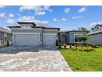 Charming single-story home featuring a three-car garage and well-manicured lawn at 11432 Shoreline Trl, Parrish, FL 34219
