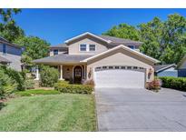 Charming two-story home with a well-manicured lawn and attached two car garage at 1324 Eckles Dr, Tampa, FL 33612