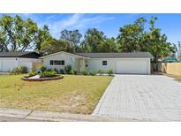 Charming single-story home with a well-manicured lawn, paved driveway, and lovely landscaping at 2274 66Th S Ave, St Petersburg, FL 33712