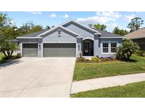 Charming single-story home with a three-car garage, manicured lawn, and inviting curb appeal at 3159 Marisa Pl, Holiday, FL 34691