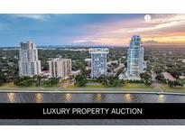 Stunning aerial view of a luxury condo building near the water at sunset at 3435 Bayshore Blvd # 2100P, Tampa, FL 33629