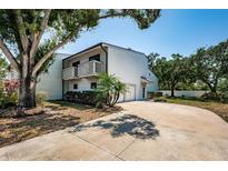 Charming two-story home featuring a double garage, dual balconies, mature trees and a welcoming driveway at 6238 92Nd N Pl # 3201, Pinellas Park, FL 33782