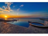 Enjoy scenic water views from this beautiful infinity pool with a built-in spa overlooking the ocean at 6408 Bright Bay Ct, Apollo Beach, FL 33572