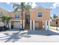 Stunning waterfront home featuring elevated construction, a two-car garage, and lush tropical landscaping at 19 Crescent S Pl, St Petersburg, FL 33711