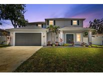 Charming two-story home boasts a well-manicured lawn and a spacious two-car garage at 3612 W Pearl Ave, Tampa, FL 33611