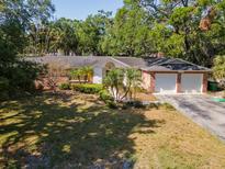 Charming brick home featuring an attached two-car garage and a well-manicured front yard at 4627 W Browning Ave, Tampa, FL 33629