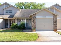 Charming townhouse with a well-maintained lawn, front patio, and attached one car garage at 6516 Remus Dr, New Port Richey, FL 34653