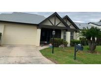 Charming home featuring an attached garage, well-maintained lawn, and inviting front entrance at 776 Lakewood Dr, Palm Harbor, FL 34684