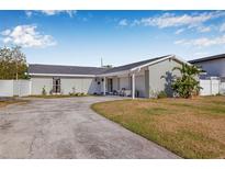 Charming single-story home featuring a gray exterior, attached garage, and well-maintained front yard at 8335 Fountain Ave, Tampa, FL 33615