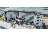 Spacious condo building featuring a porte cochere and well-maintained landscaping, offering an inviting entrance at 9 Forbes Pl # 205, Dunedin, FL 34698
