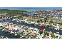Waterfront property with canal access, lush landscaping, boat dock and quick access to Tampa Bay at 907 Golf Island Dr, Apollo Beach, FL 33572
