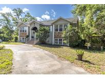 Charming two-story home with stone accents, well-manicured lawn, and inviting front entrance at 9520 Indale Dr, New Port Richey, FL 34654