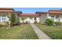 Inviting single-story home featuring a well-maintained lawn and charming front entrance at 11511 113Th St # 24C, Largo, FL 33778