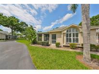 Charming single-story home with lush landscaping and large windows at 1211 Golfview Woods Dr, Sun City Center, FL 33573