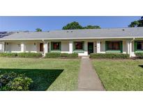 Charming single-story home featuring well-maintained landscaping and a welcoming walkway leading to the entrance at 2557 Laurelwood Dr # 10E, Clearwater, FL 33763