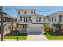 Beautiful two-story home with a well-manicured front yard and a two-car garage at 3310 W Wyoming Ave, Tampa, FL 33611