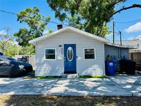 Charming single-story home with blue door, manicured lawn, and ample parking at 3498 13Th S Ave, St Petersburg, FL 33711