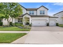 Charming two-story home featuring a three car garage, landscaped yard and inviting curb appeal at 4108 Mellon Dr, Odessa, FL 33556