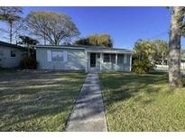 Charming single-story home with a well-manicured lawn and mature trees at 4301 15Th N Ave, St Petersburg, FL 33713
