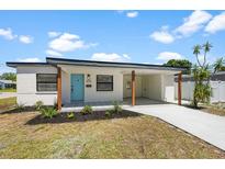 Charming single-story home with a modern design, fresh landscaping, and a covered carport at 4675 26Th N Ave, St Petersburg, FL 33713