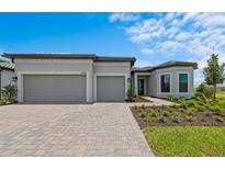Charming single-story home showcasing a manicured lawn, paved driveway, and a spacious three-car garage at 5958 Talon Preserve Dr, Nokomis, FL 34275