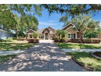 Stunning exterior showcases a lush landscape, long driveway, and a double door entry at 607 Vintage Way, Brandon, FL 33511