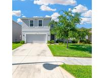 Charming two-story home with a well-manicured lawn and a spacious driveway leading to the attached two-car garage at 16149 Tuscany Hillside Rd, Odessa, FL 33556