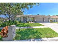 Charming single-story home featuring a well-manicured lawn and a three-car garage at 2113 Golf Manor Blvd, Valrico, FL 33596